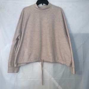 Long sleeve cream colored blouse.